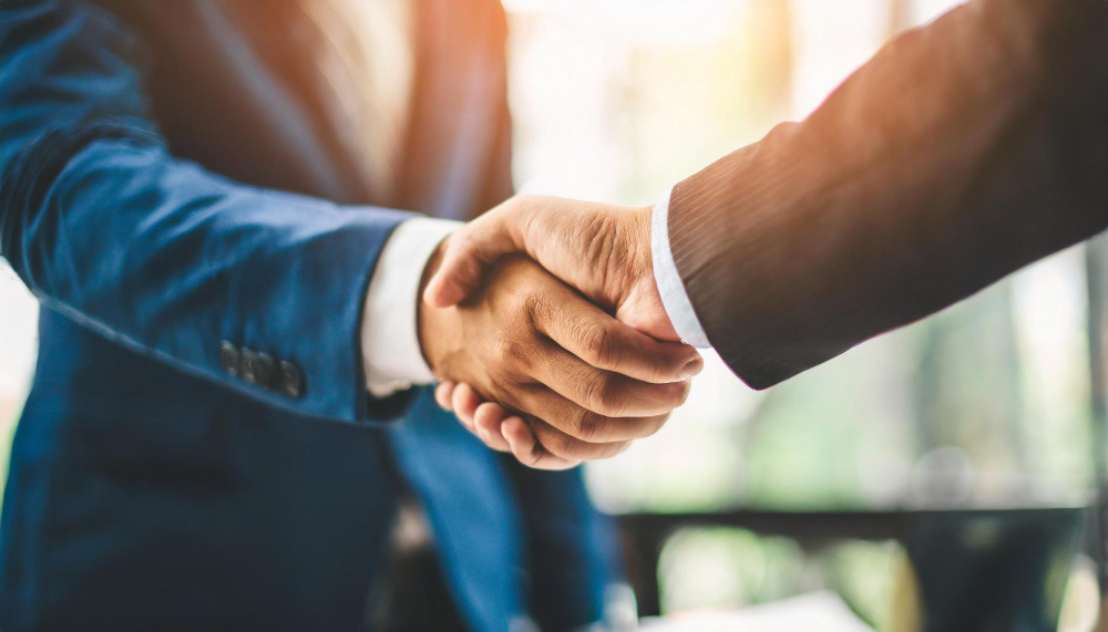 Two business people shaking hands in agreement