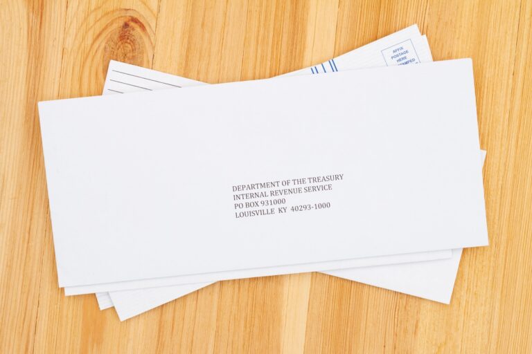 Business envelope addresses to IRS for paying taxes on a wood desk